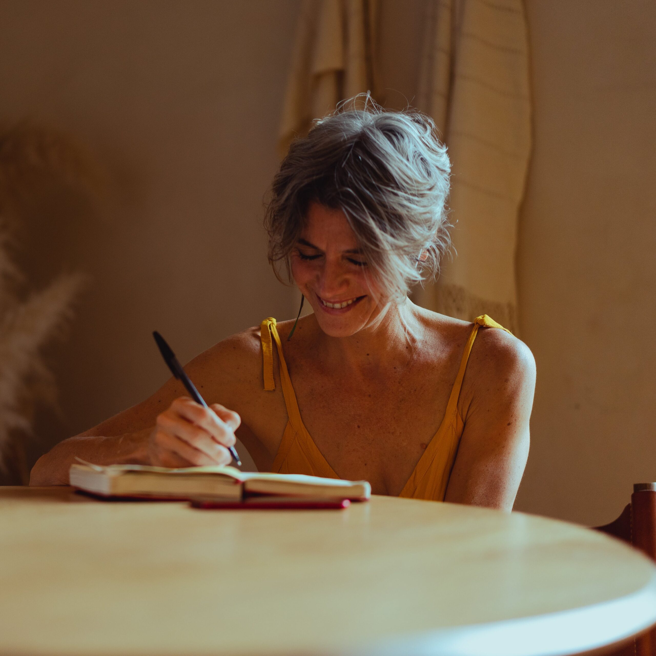 old-woman-happily-writing-her-book